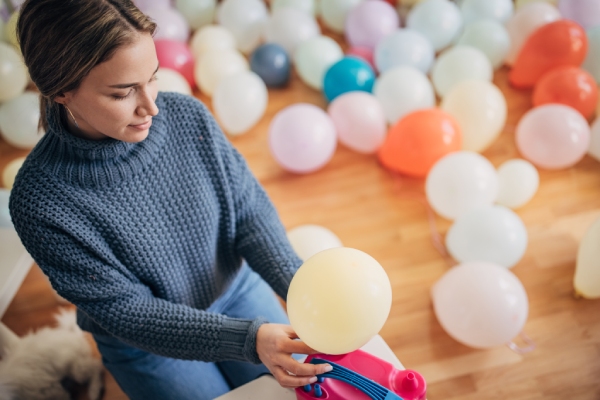 partyplus girl blowing up balloons